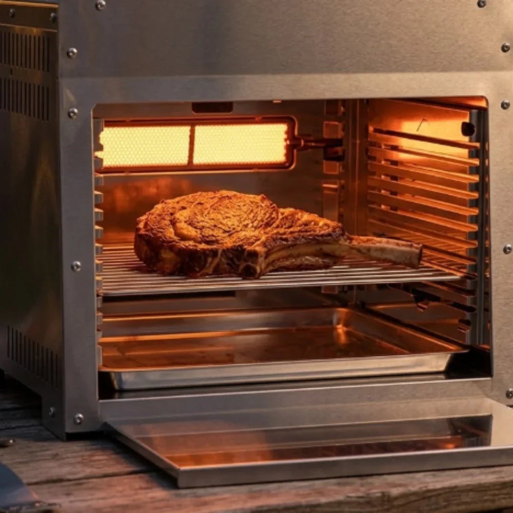 Infrared grill searing a thick steak with an even golden-brown crust at night.