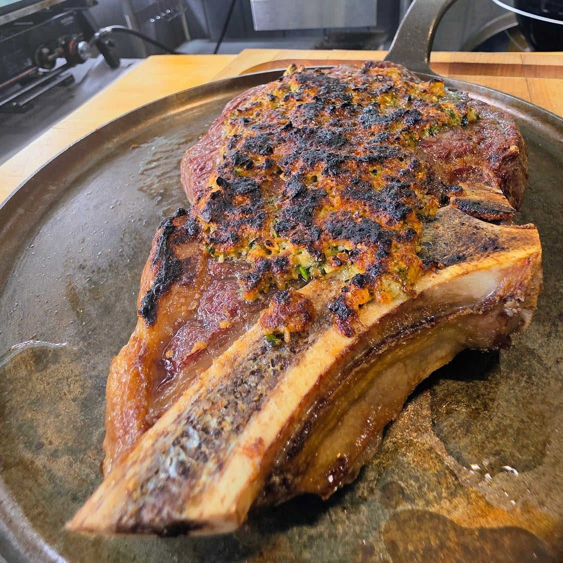 A Garlic Parmesan-Crusted Ribeye, fresh off the Bighorn Steak Grill was placed on a metal platter