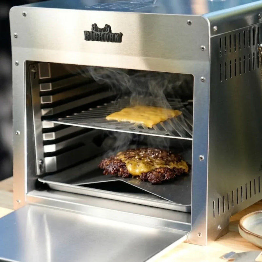 Smash burger cooking on infrared grill with melting cheese